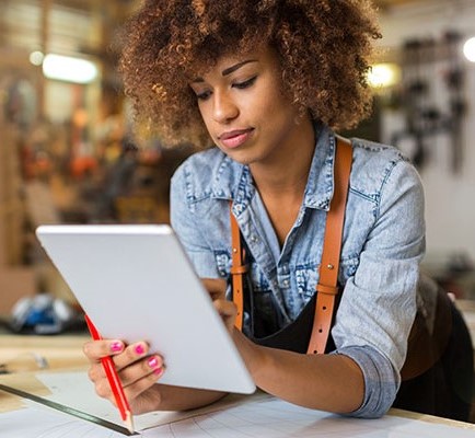 woman paying a bill through Quick Pay on her tablet